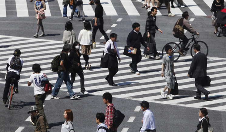People cross a street in Tokyo